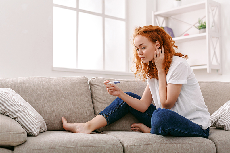 Woman reading pregnancy test.